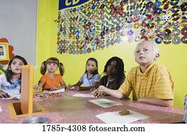 Children drawing and paying attention in art class