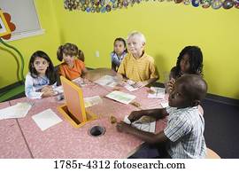 Children drawing and paying attention in class