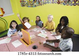 Children drawing and paying attention in class