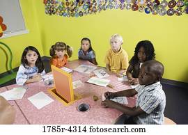 Children drawing and paying attention in class