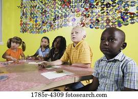Children drawing and paying attention in art class