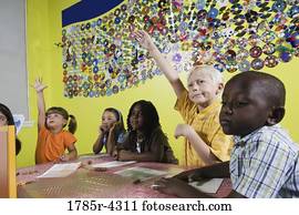 Children drawing and paying attention in class