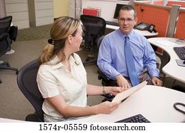 Businessman and a businesswoman discussing paperwork