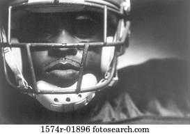 Close-up of an American football player wearing a helmet Close-up of an American football player wearing a helmet