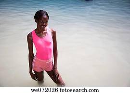 Jamaican woman in bikini with jamaican flag on beach. Negril. Jamaica