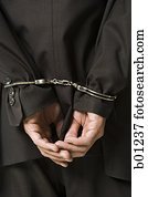 Rear view of a businessman in handcuffs