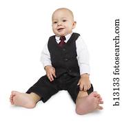 Baby boy in business suit sitting