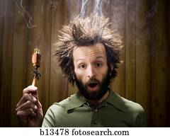 Man after electric shock with electric plug and smoke