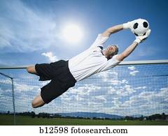 Soccer goalkeeper making diving save Soccer goalkeeper making diving save
