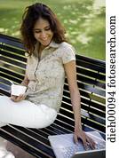 Woman on a laptop outside