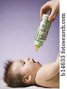 Baby drinking from bottle with US currency in it