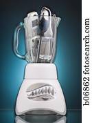 Kitchen blender filled with consumer electronics