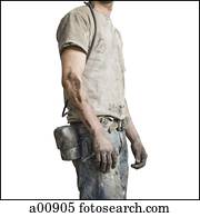 Mine worker in overalls from the neck down