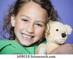 girl hugging huge teddy bear