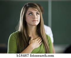 Young woman with hand over heart.