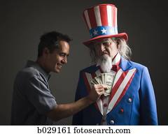 man taking money out of uncle sam's coat