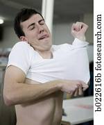 man putting on a shrunken t-shirt