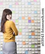 Portrait of young woman looking over shoulder, studio shot