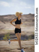 Profile of a young woman jogging