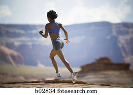 Rear view of a young woman jogging