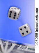 Close-up of a pair of dice above US currency