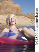 Young woman sitting in an inflatable raft