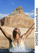 Young woman splashing in water