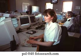 Woman in Police Office using Telephone Headset Woman in Police Office using Telephone Headset
