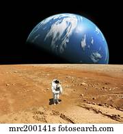 An astronaut standing on a barren world with planet rising in background.