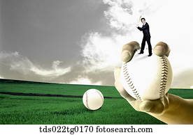 business man is holding bat on the baseball which was hold by someone's hand