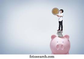 a boy holding a coin a boy holding a coin