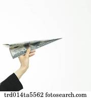 business concept/a businesswoman holding a paper airplane