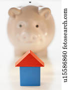 Piggy bank and symbolic house