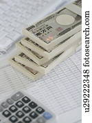 Stack of Japanese money and calculator