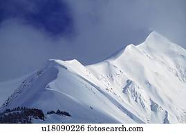 Snow cornice leading up to mountain peak