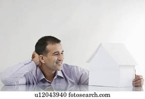 Man looking at a house model