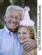 Senior man embracing granddaughter