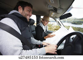 Happy couple in their car