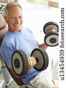 Senior Man Working With Weights In Gym Senior Man Working With Weights In Gym