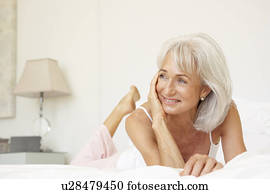 Senior Woman Relaxing On Bed