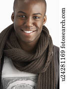 Young Man Wearing Warm Winter Clothing In Studio