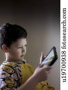 Young boy playing on handheld device