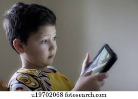 Young boy playing on handheld device