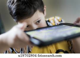 Young boy playing on handheld device