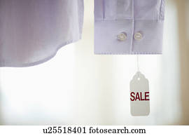 Close up of shirt cuff with sale tag