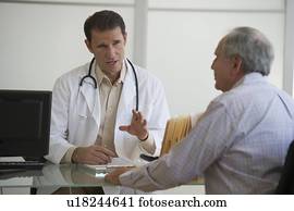 Doctor and female patient sitting in office