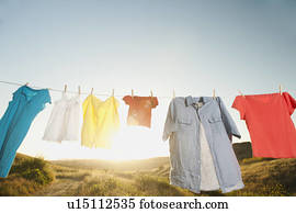 Laundry hanging on clothesline against blue sky