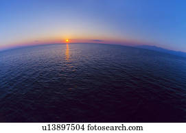 Aerial view of horizon over sea at sunrise