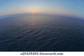 Aerial view of horizon over sea at sunrise