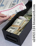 Hand inserting valuables into safe deposit box